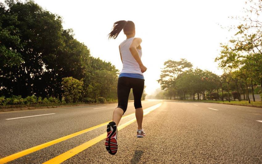 ragazza corre su strada asfaltata