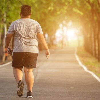 Exercise and healthy concept : Fat man running in the park