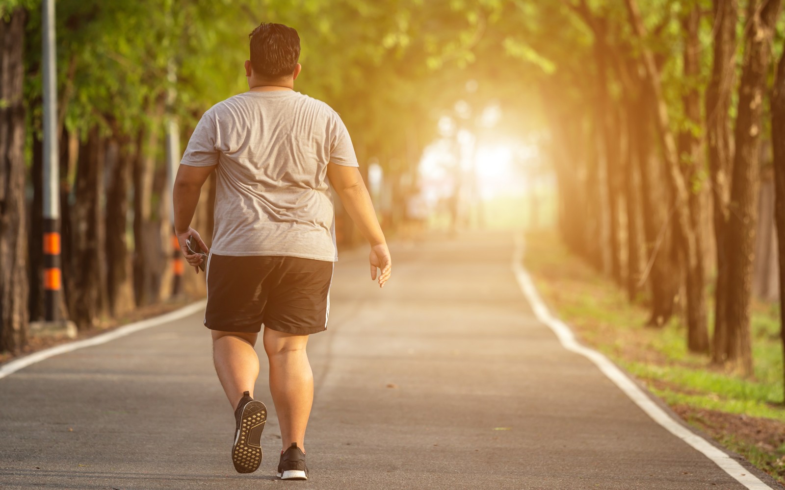 Exercise and healthy concept : Fat man running in the park